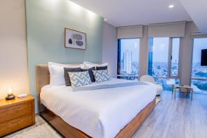 En eller flere senge i et værelse på Capitalia Plaza Residences Reforma