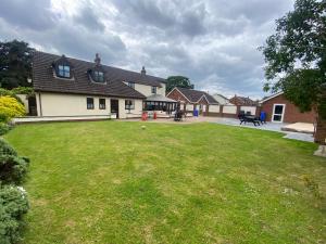 a house with a yard with a grassy yard at Parkside Guest House in Pollington