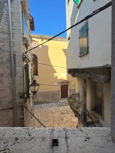 an empty alley with a building and a street at Studios OneThreeFive in Rovinj