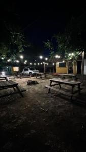a group of picnic tables in a park at night at Hostel Native in Boa Vista