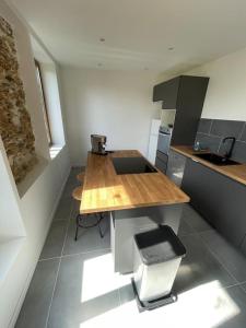 a kitchen with a wooden counter top in a room at Charmante dépendance avec jardin in Vaux-sur-Seine