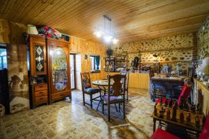 a kitchen with a table and chairs in a room at Villa Provance & Swimming Pool in Sighnaghi