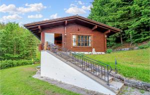 a log cabin with a staircase in front of a house at 3 Bedroom Beautiful Home In Strallegg in Strallegg