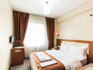 Postel nebo postele na pokoji v ubytování Mint Residence Taksim