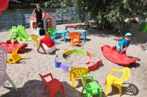 two children playing in a playground with play equipment at Plein centre de Visé in Visé