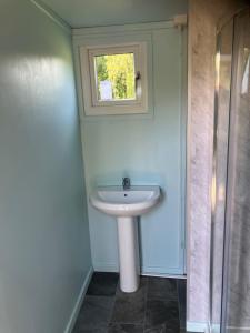 a bathroom with a sink and a window at Pod Lois in Dolgellau