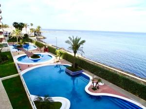 a row of swimming pools next to the ocean at Mar y desconexión in San Javier