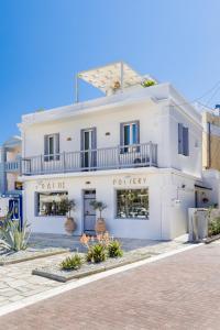a white building with a pottery store at The Pottery House in Skopelos Town