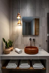 a bathroom with a sink and a mirror at The Pottery House in Skopelos Town +36 photos