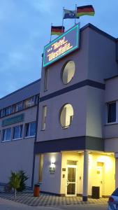 a hotel with a sign on top of a building at Stadt-gut-Hotel Westfalia in Halle an der Saale
