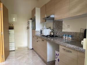 a kitchen with wooden cabinets and a counter top at The garden corner in Bouznika