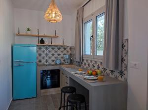 a kitchen with a blue refrigerator and a counter at Rhodes Soul luxury suites in Afantou