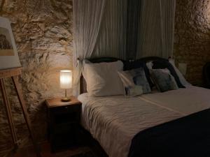 a bedroom with a bed with a lamp on a table at Château de Monsac in Monsac