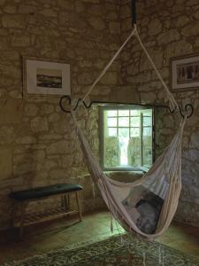 a hammock in a room with a window at Château de Monsac in Monsac