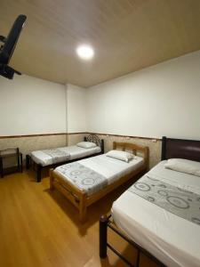 Postel nebo postele na pokoji v ubytování Hostal Casa Primavera