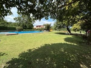 a park with a large yard with trees and grass at Cabaña Emilia in San Javier
