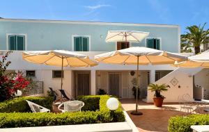 a house with umbrellas in front of it at PonzaSmeralda Le Forna in Ponza