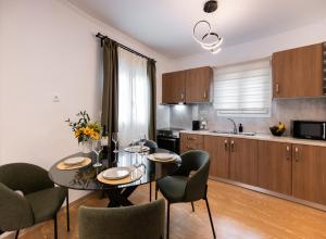 a kitchen and dining room with a table and chairs at Marina's house in Nydri