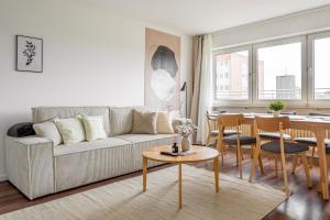 a living room with a couch and a table at Global Living - Design Apartments I Terrace I Kitchen I Smart-TV I Parking space I München in Munich