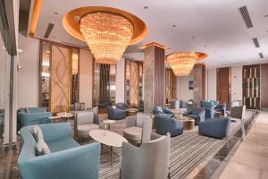 a lobby with chairs and tables and chandeliers at Best Western Premier Ottoperla Hotel in Istanbul
