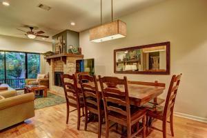 a dining room with a table and chairs and a fireplace at River Remedy CW C110 in New Braunfels