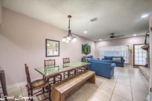 a living room with a table and a blue couch at The Iron Cactus Condo on the Comal CW C102 in New Braunfels
