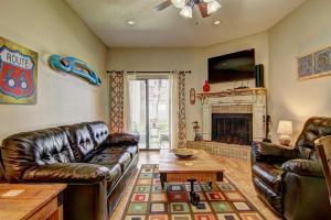 a living room with leather furniture and a fireplace at Go With The Flow CW B103 in New Braunfels