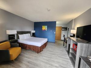 a hotel room with a bed and a tv at Super 8 by Wyndham Hayward WI in Hayward