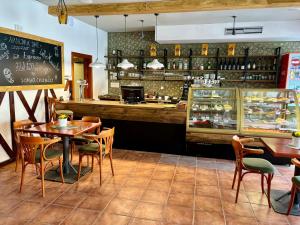 a restaurant with tables and chairs and a counter at Penzion Pohádka in Třeboň