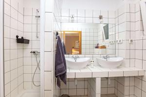 a bathroom with two sinks and a mirror at Family-friendly apartments with swimming pool Vinisce, Trogir - 22873 in Vinišće +20 photos