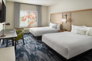 a hotel room with two beds and a desk at Fairfield Inn & Suites Locust Grove I-75 South in Locust Grove