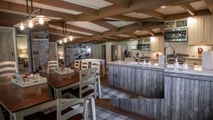 a kitchen with a table and a counter top at Creekside Farmstead Hot Tub with Brand New Pool and BBQ in Auburn