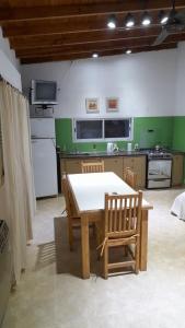 a kitchen with a table and chairs in a room at El Naranjo in Chascomús +4 photos