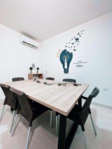 a table with chairs and a light bulb and stars on a wall at Hotel Boutique Gao in Cúcuta