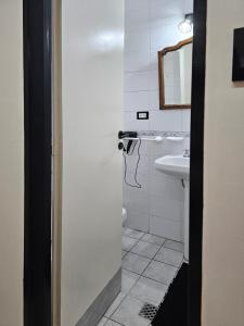 een badkamer met een wastafel, een toilet en een spiegel bij Monoambiente moderno e inteligente en B Sur Cochera Precio en USD in San Miguel de Tucumán +8 foto's