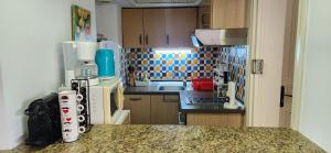 a small kitchen with a counter top and a counter top at Appartement marina hammamet in Yasmine +24 photos