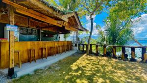 a bar with stools in front of a building at La Concepcion Cove Garden Resort in Moalboal