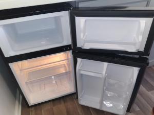 an empty refrigerator with its door open in a kitchen at LA Love Home in Los Angeles