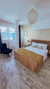 a large bedroom with a large bed and a chair at Horizon Bleu - Sidi Bou Saïd in Sidi Bou Saïd