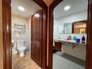 a bathroom with a toilet and a sink at Villa plage tiguert résidence les méridiennes in Agadir +23 photos