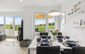 a dining room and living room with a table and chairs at Stunning Home In Tossens With Sauna in Stick