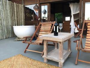 a table and two chairs and a bath tub at Casa Ocean Trancoso in Trancoso