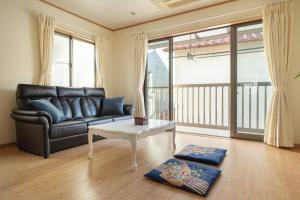 a living room with a couch and a table at Dryokan Kumanocho in Tokyo +51 photos