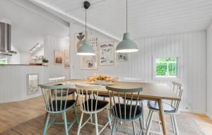 a dining room with a table and chairs at 4 Bedroom Cozy Home In Ansager in Ansager