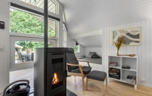 a living room with a fireplace and a bedroom at 4 Bedroom Cozy Home In Ansager in Ansager