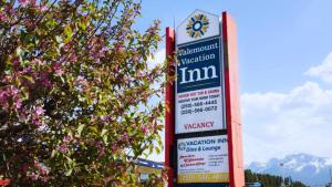 a sign for a pharmacy next to a tree at Valemount Vacation Inn in Valemount
