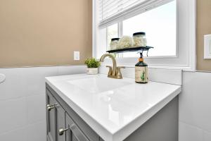 a white kitchen with a sink and a window at Comfort Stay in Boston +45 photos