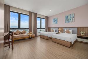 Postel nebo postele na pokoji v ubytování ATP Galaxy Hotel & Apartment Danang