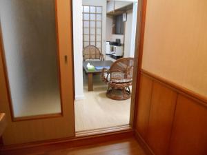 a room with a mirror and a dining room with a table at 駅徒歩5分どこへも大阪駅へ直結どこへもすぐの大型庭付GlampingHouse in Osaka