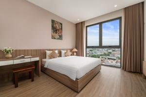 Postel nebo postele na pokoji v ubytování ATP Galaxy Hotel & Apartment Danang + 37 fotografií